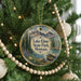 A circular ornament hanging on a Christmas tree, featuring a scenic image of Lake Elmo State Park, Montana.