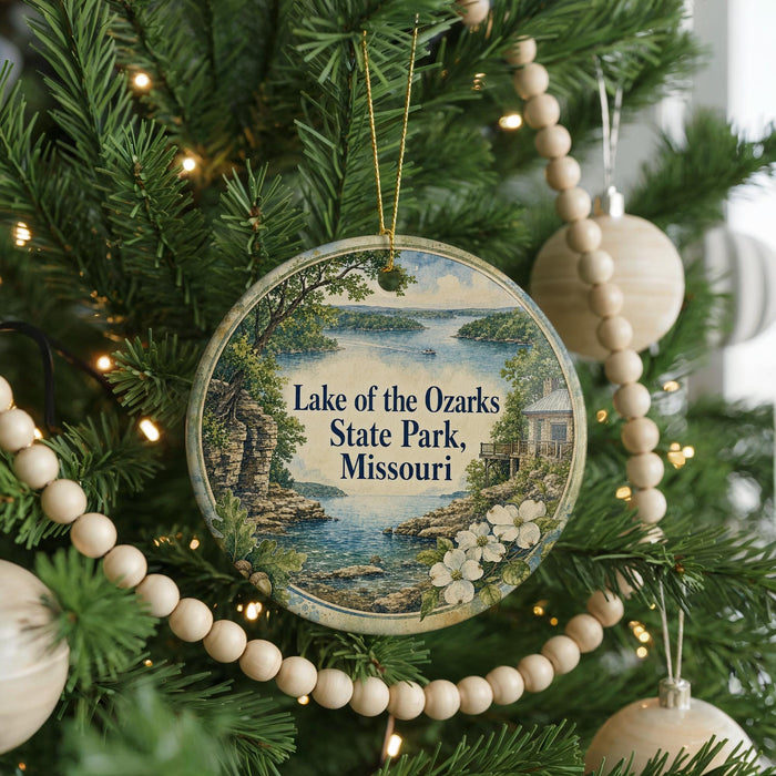 A round ornament hanging on a Christmas tree, featuring a scenic image of Lake of the Ozarks State Park, Missouri.
