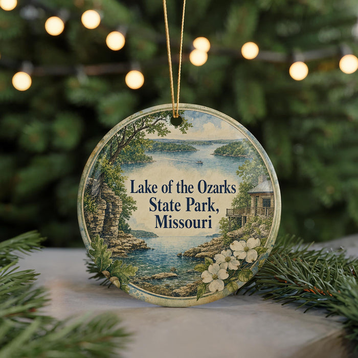 A circular ornament with a scenic image of Lake of the Ozarks State Park, Missouri, surrounded by greenery and a string of lights.