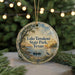 A circular ornament with a painting of Lake Tawakoni State Park in Texas, featuring a boat on the water and a bird in the foreground.