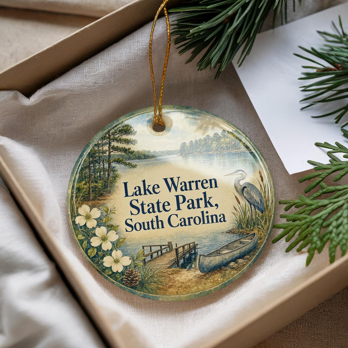 A round ornament with a scenic image of Lake Warren State Park, South Carolina, featuring a lake, trees, and a bird.