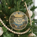 A round ornament hanging on a Christmas tree, featuring a scenic landscape of Lake Whitney State Park, Texas.