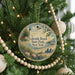 A round ornament hanging on a Christmas tree, featuring a lighthouse and a beach scene with a message that reads "Lakeside Beach State Park, New York".