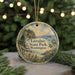A round ornament with a scenic landscape of Larabee State Park, Washington, featuring a bird, pine trees, and a body of water.