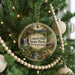A round ornament on a Christmas tree, featuring a scenic image of Laurel Hill State Park in Pennsylvania.