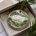 A decorative ornament in a box, featuring a scenic landscape of Laurel Ridge State Park in Pennsylvania.