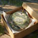 A decorative ornament in a box, featuring a scenic landscape of Lebanon State Forest, New Jersey.