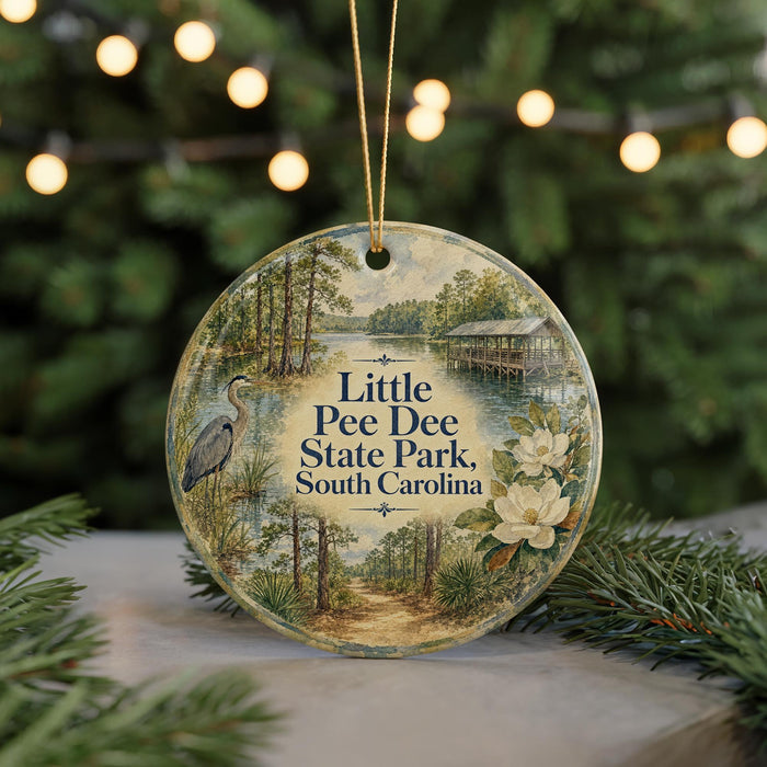 A round ornament with a painting of a bird and a landscape, featuring the text "Little Pee Dee State Park, South Carolina".