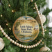 A circular ornament hanging on a Christmas tree, featuring a scenic landscape of Little Sahara State Park, Oklahoma.