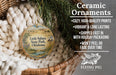 Ceramic ornaments, including a Little Sahara State Park ornament, are displayed in a basket with greenery.
