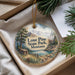 A decorative ornament with a scenic landscape of mountains, pine trees, and a cabin, hanging from a string.