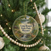 A round ornament hanging on a Christmas tree, featuring a scenic image of Long Branch State Park, Missouri.