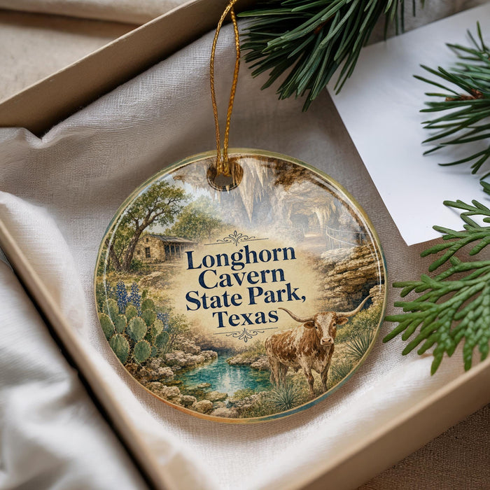 A decorative ornament with a scenic image of the Longhorn Canyon State Park in Texas, featuring a bull and a natural landscape.