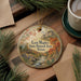 A decorative ornament with a scenic landscape of a river, mountains, and fall foliage, along with the text "Lost Maples State Natural Area, Texas".