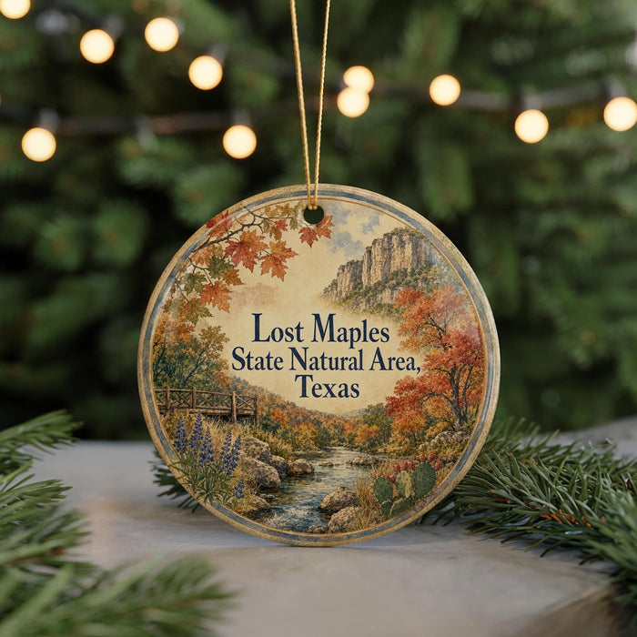 A round ornament with a scenic image of a river, mountains, and fall foliage, along with the text "Lost Maples State Natural Area, Texas".