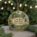 A round ornament with a scenic illustration of Lost River State Park, West Virginia, hanging from a string.
