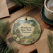 A decorative ornament featuring a scenic landscape of Manchester State Park in Washington, with a boat on the water and pine trees surrounding it.