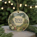 A round ornament with a scenic image of Manchester State Park, Washington, featuring a boat on a lake, surrounded by pine trees and a cabin.