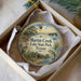A decorative ornament in a box, featuring a scenic image of Martin Creek Lake State Park in Texas.