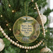 A round ornament hanging on a Christmas tree, featuring a scenic image of Mary Jane Thurston State Park in Ohio.