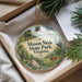 A decorative ornament with a scenic landscape of Mason Neck State Park, Virginia, featuring a bird, a deer, and a bridge.