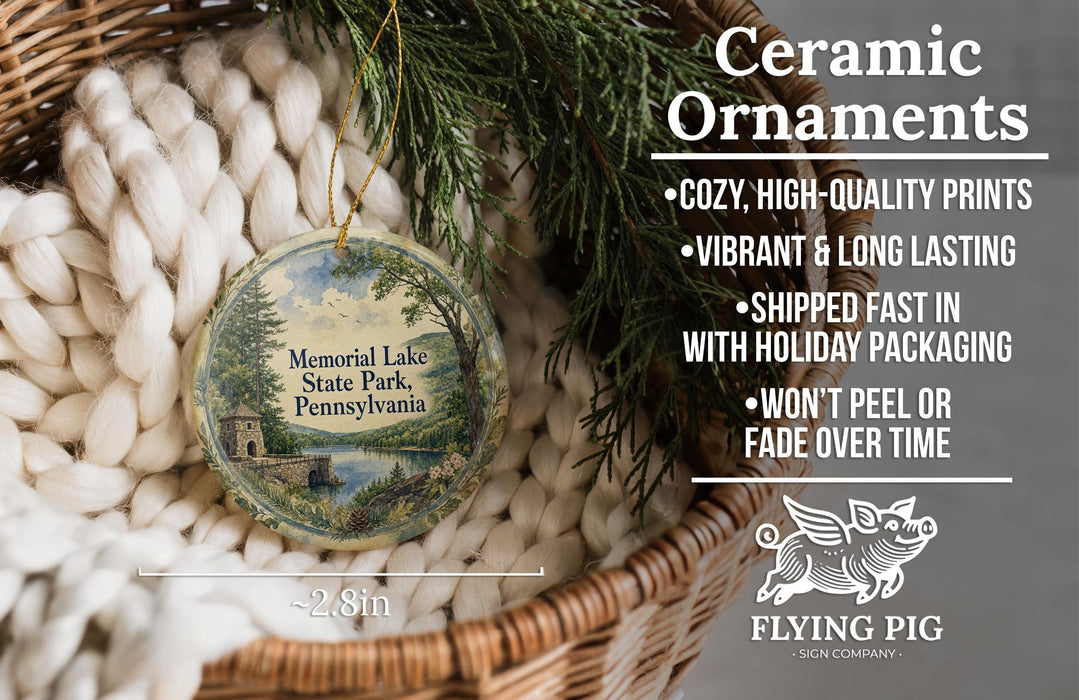 Ceramic ornaments, including a round ornament with a scenic landscape, are displayed in a woven basket.