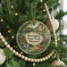 A Christmas tree decorated with ornaments, including a circular ornament with a scenic illustration of Meramec State Park, Missouri.