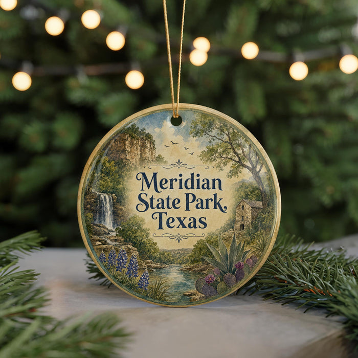 A round ornament with a scenic landscape of Meridian State Park in Texas, featuring a waterfall, pine trees, and other natural elements.