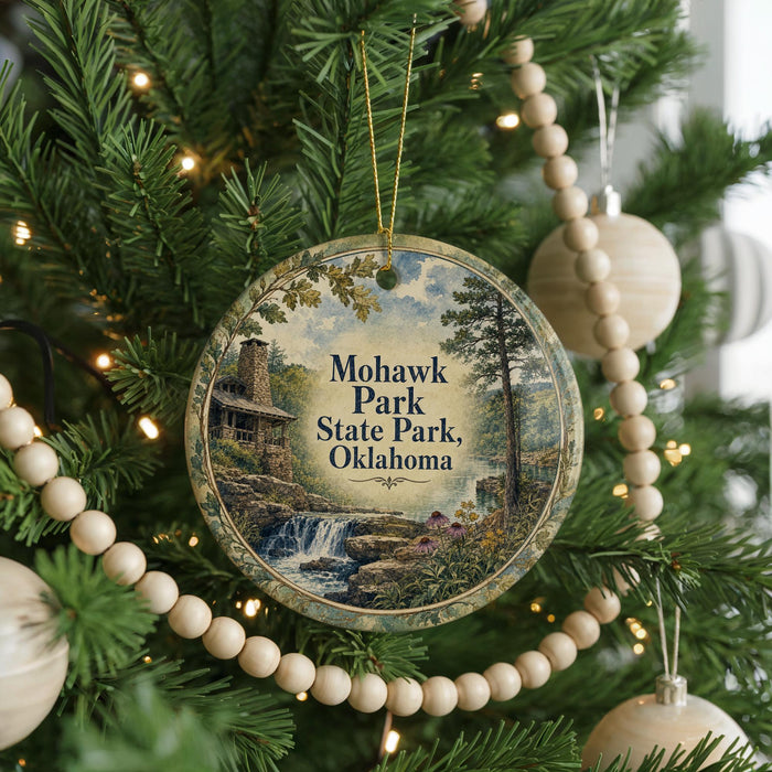 A circular ornament hanging on a Christmas tree, featuring a scenic image of Mohawk Park, Oklahoma.