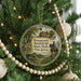 A round ornament hanging on a Christmas tree, featuring a scene from the historic Battlefield State Park in New Jersey.