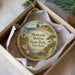 A decorative ornament in a box, featuring a lighthouse and a scenic landscape, with the text "Montauk Downs State Park, New York" prominently displayed.