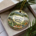 A decorative ornament in a box, featuring a scenic landscape of Mount Philo State Park in Vermont.