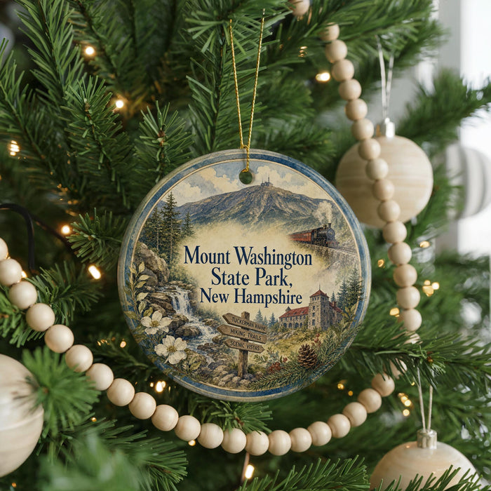 A round ornament hanging on a Christmas tree, featuring a scenic image of Mount Washington State Park in New Hampshire.