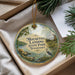A decorative ornament with a scenic image of a lake and surrounding landscape, featuring a bird in the foreground.