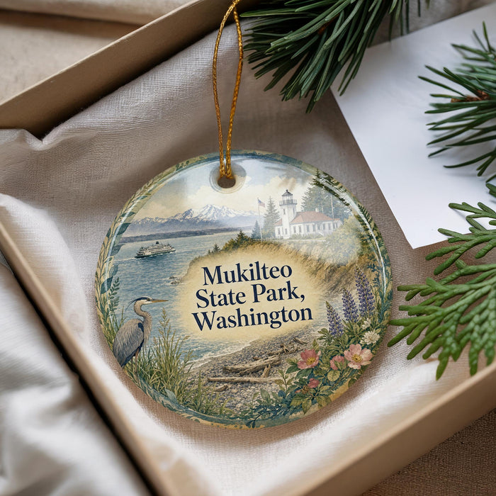 A decorative ornament with a scenic image of Mukilteo State Park, Washington, featuring a lighthouse, a boat, and a bird.