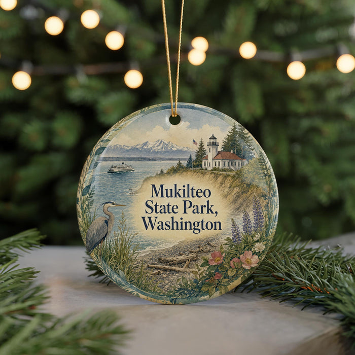 A decorative ornament featuring a scenic image of Mukilteo State Park in Washington, with a lighthouse and a boat in the background.