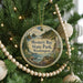 A round ornament hanging on a Christmas tree, featuring a scenic image of Mystery Bay State Park in Washington.