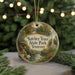 A round ornament with a scenic image of a forest and a river, surrounded by Christmas lights.