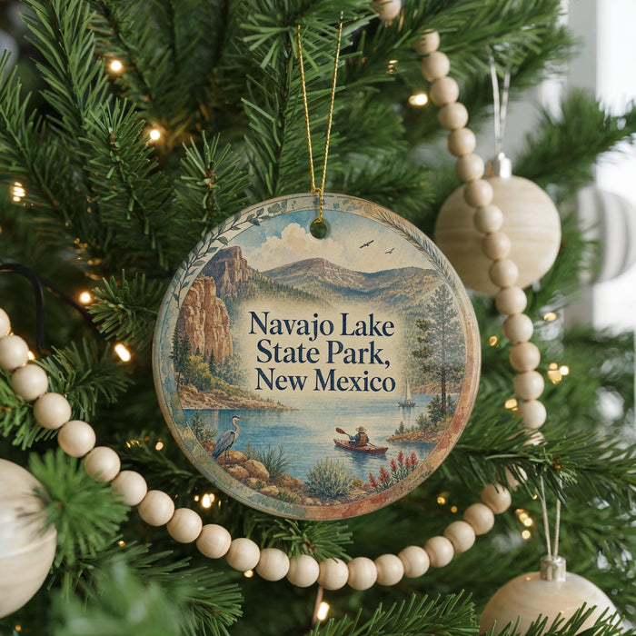 A round ornament hanging on a Christmas tree, featuring a scenic image of Navajo Lake State Park, New Mexico.