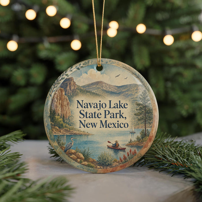 A decorative ornament featuring a scenic landscape with mountains, a lake, and a person in a boat, with the text "Navy Lake State Park, New Mexico" prominently displayed.