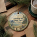 A decorative ornament with a scenic landscape of Nehalem Bay State Park, Oregon, featuring a bird, pine trees, and a body of water.