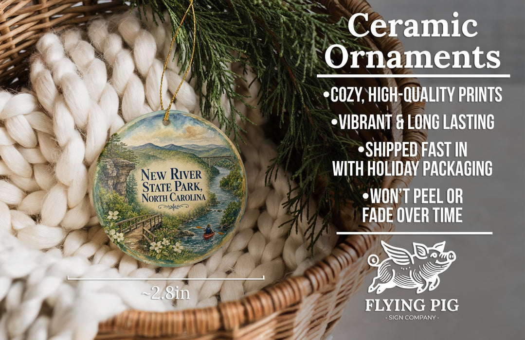 Ceramic ornaments, featuring a New River State Park ornament with a scenic landscape, are displayed in a woven basket.