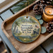 A decorative ornament featuring the text "Newtown Battlefield State Park, New York" surrounded by a scenic landscape, including a tree, a monument, and pine cones.