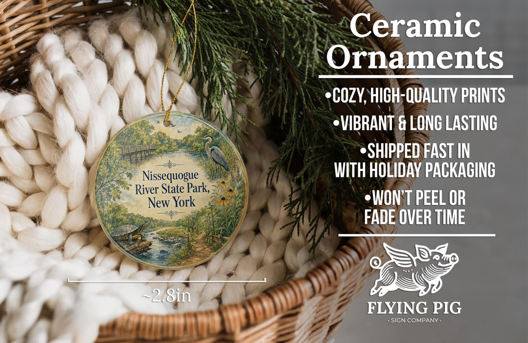 Ceramic ornaments, including a round ornament with a river scene and a bird, are displayed in a basket.