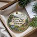 A decorative ornament with a scenic image of Norris Dam State Park, Tennessee, hanging from a string.