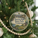 A round ornament hanging on a Christmas tree, featuring a scenic image of Norris Dam State Park, Tennessee.