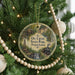 A round ornament hanging on a Christmas tree, featuring an illustration of a train and a building, with the text "OIL CREEK STATE PARK, Pennsylvania" displayed on it.