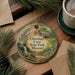 A decorative ornament featuring a scenic image of Onondaga Cave State Park, Missouri, with pine branches and a cup of coffee nearby.