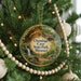 A round ornament hanging on a Christmas tree, featuring a scenic image of the Onondaga Cave State Park in Missouri.