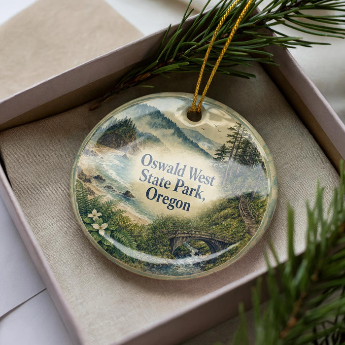 A decorative ornament in a box, featuring a scenic landscape with mountains, trees, and a bridge.